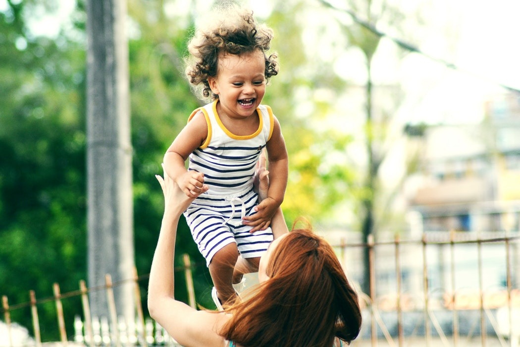 Mom holding up Baby