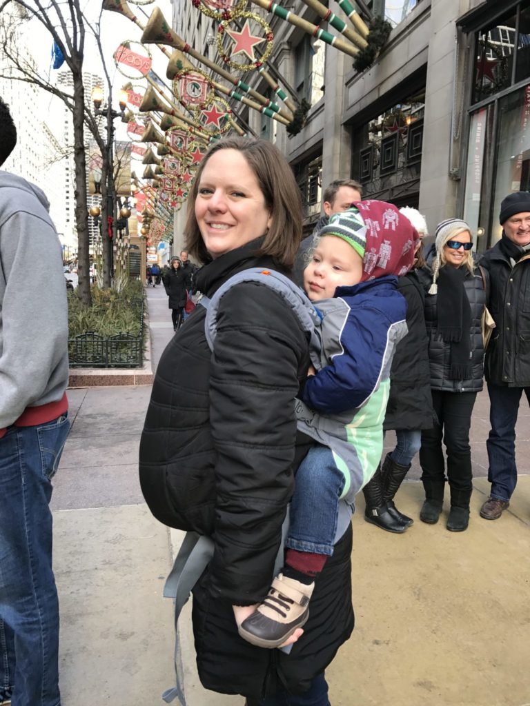 Mom wearing baby in backpack carrier