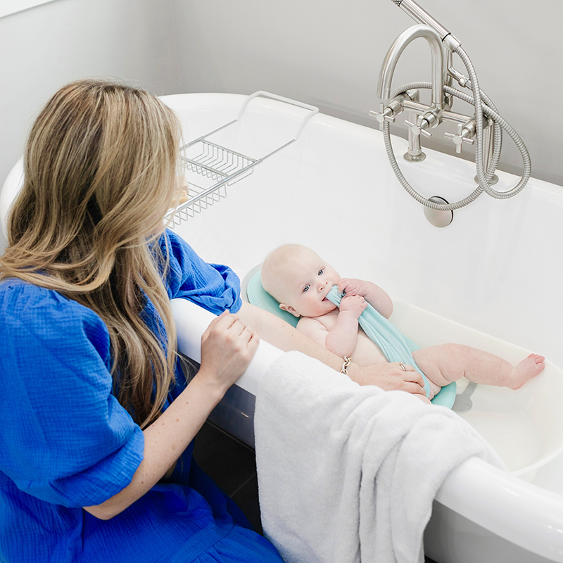 Infant in bath oasis tub with mom