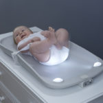 Baby lying on the Glow changing pad
